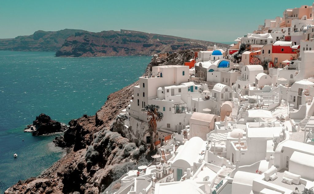 Sunset over the sea and rooftops in Santorini, Greece